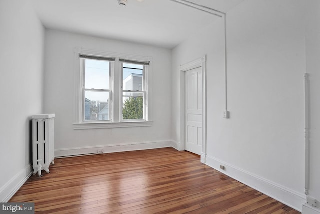 1033 Newton St NE, Washington, DC 20017 - empty room featuring radiator heating unit and wood finished floors