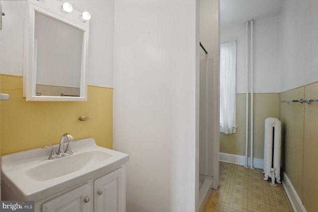 1033 Newton St NE, Washington, DC 20017 - bathroom with radiator heating unit, a shower, vanity, and tile patterned floors