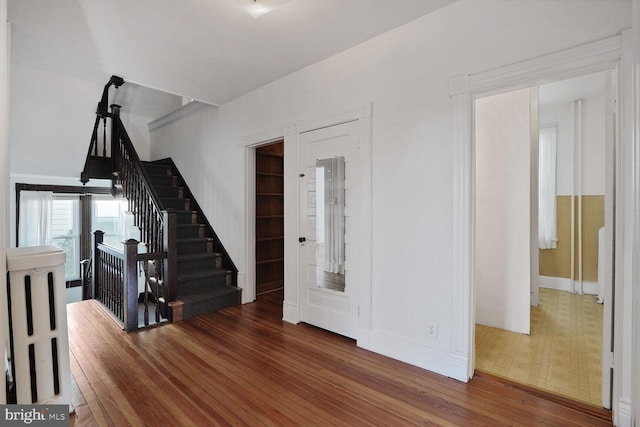 1033 Newton St NE, Washington, DC 20017 - staircase featuring hardwood / wood-style floors and baseboards