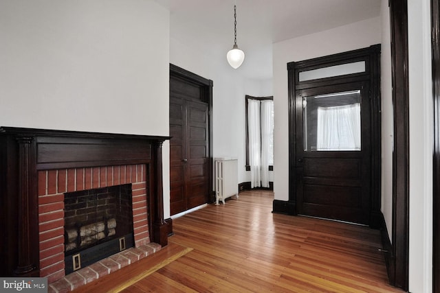 1033 Newton St NE, Washington, DC 20017 - foyer entrance with a brick fireplace and light wood-style floors