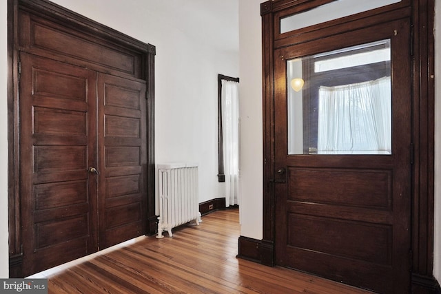 1033 Newton St NE, Washington, DC 20017 - foyer entrance featuring radiator heating unit and dark wood-type flooring
