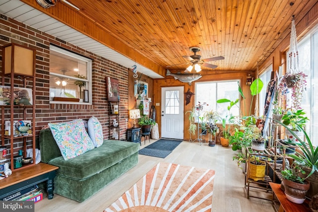 sunroom with wooden ceiling and a ceiling fan