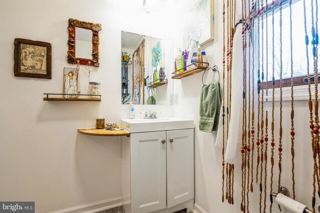 bathroom featuring baseboards and vanity