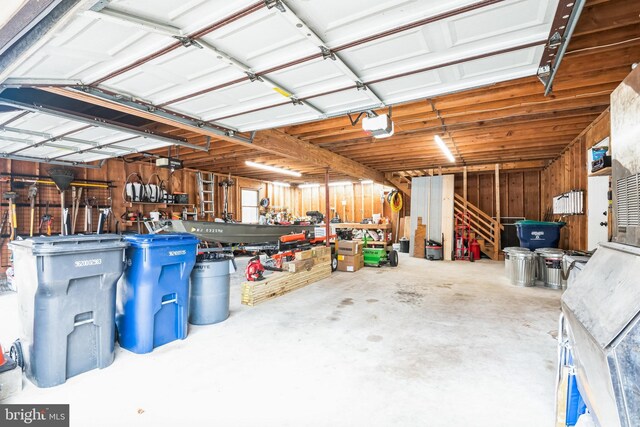 garage with a workshop area and a garage door opener