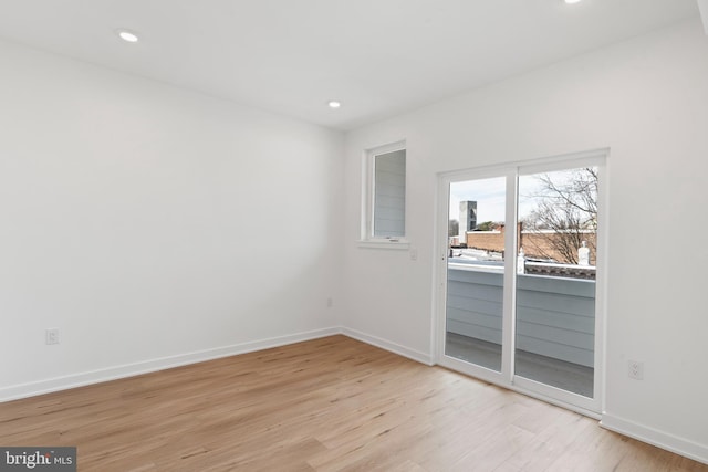 spare room with recessed lighting, baseboards, and light wood finished floors