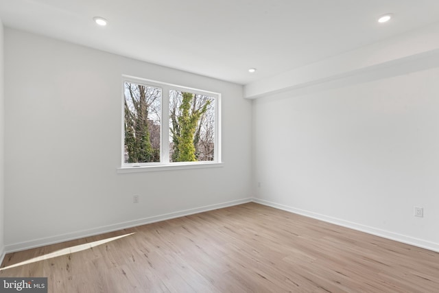 unfurnished room with recessed lighting, baseboards, and light wood finished floors