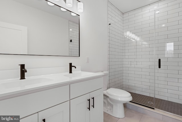 full bath featuring a sink, toilet, a stall shower, and double vanity