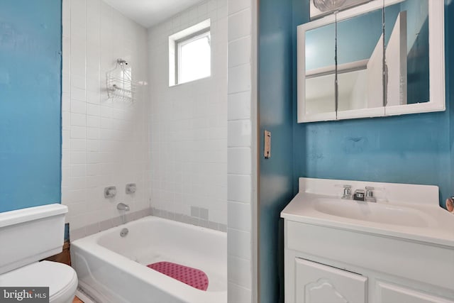 bathroom with shower / bathtub combination, vanity, and toilet
