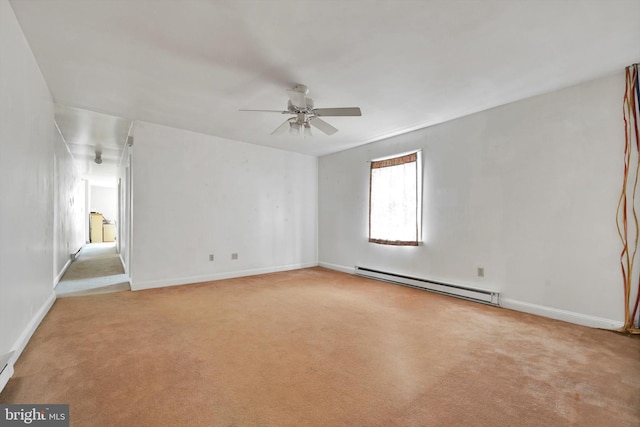 carpeted empty room with a baseboard radiator, baseboards, and ceiling fan