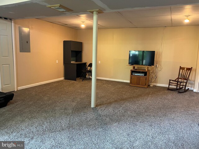 finished basement with baseboards, carpet flooring, a drop ceiling, and electric panel