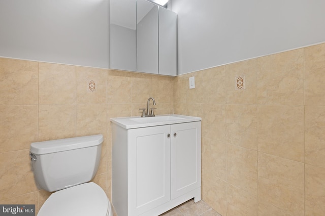 505 N Rose St, Baltimore, MD 21205 - bathroom featuring tile patterned flooring, vanity, toilet, and tile walls