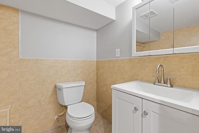 505 N Rose St, Baltimore, MD 21205 - bathroom featuring tile patterned floors, visible vents, toilet, tile walls, and vanity