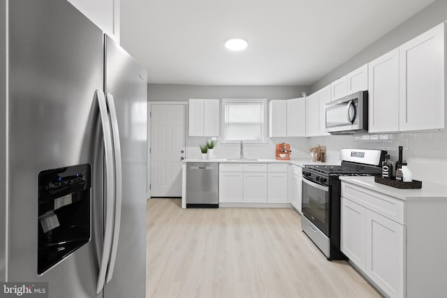 505 N Rose St, Baltimore, MD 21205 - kitchen featuring a sink, tasteful backsplash, appliances with stainless steel finishes, and white cabinetry