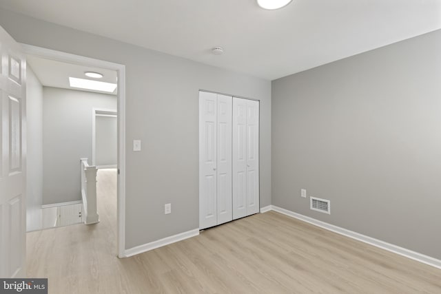 505 N Rose St, Baltimore, MD 21205 - unfurnished bedroom featuring visible vents, baseboards, and light wood-style floors