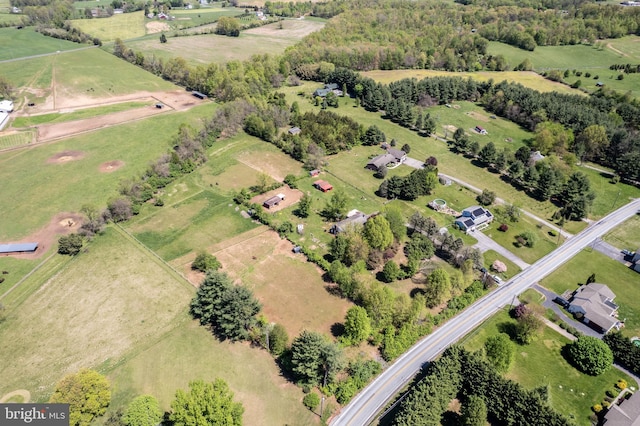 birds eye view of property with a rural view