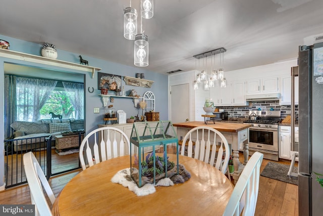 dining area featuring light wood finished floors
