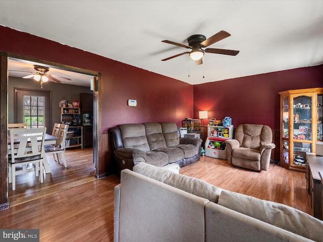 living room featuring a ceiling fan and wood finished floors