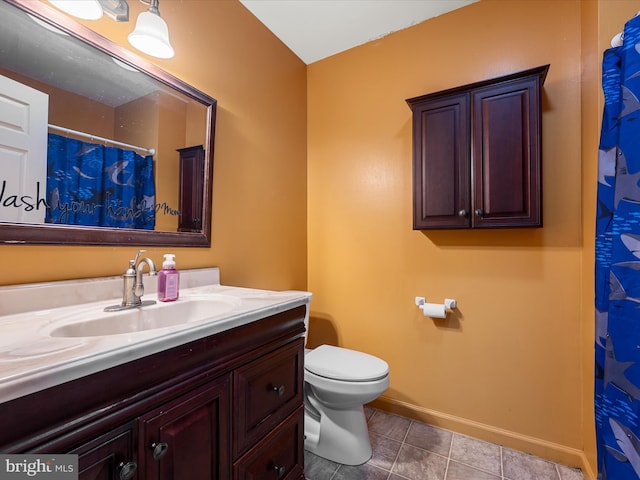 full bathroom with baseboards, tile patterned floors, toilet, and vanity