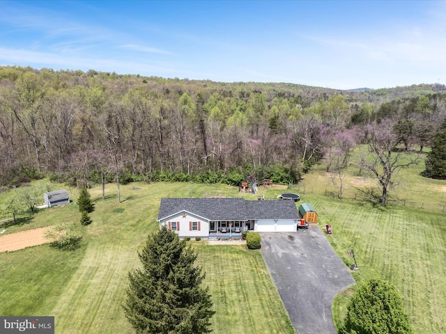 birds eye view of property with a forest view