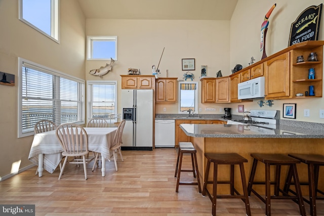 510 Bay Point Rd, Cedarville, NJ 08311 - kitchen with white appliances, a peninsula, light wood finished floors, and a sink