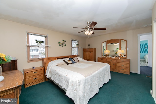 bedroom with a ceiling fan, baseboards, and dark colored carpet