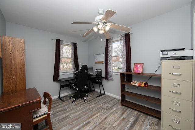 office featuring baseboards, ceiling fan, and wood finished floors