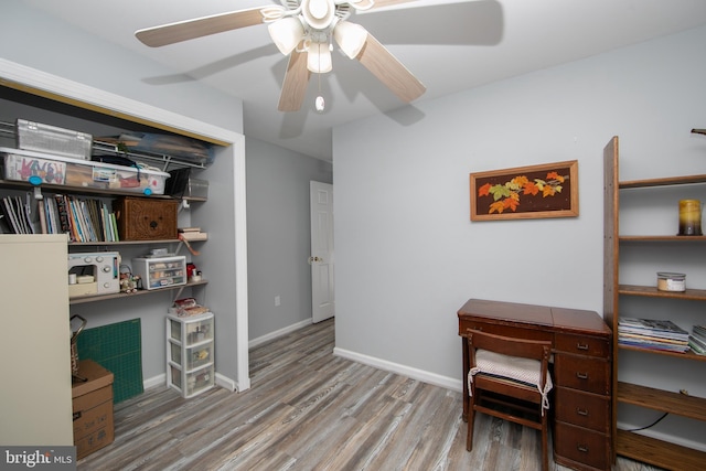 office space featuring baseboards, wood finished floors, and ceiling fan