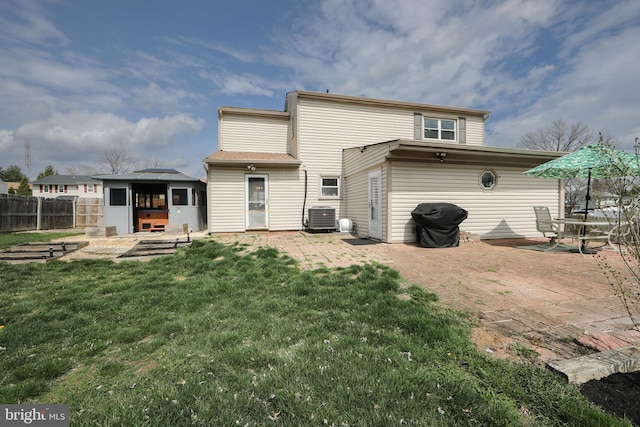 back of house featuring a patio area, fence, central AC, and a yard