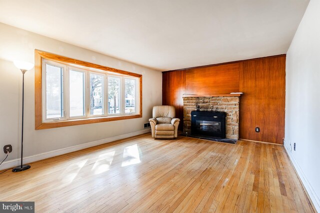 526 Baltimore Annapolis Blvd, Severna Park, MD 21146 - unfurnished room featuring baseboards, a stone fireplace, and hardwood / wood-style floors