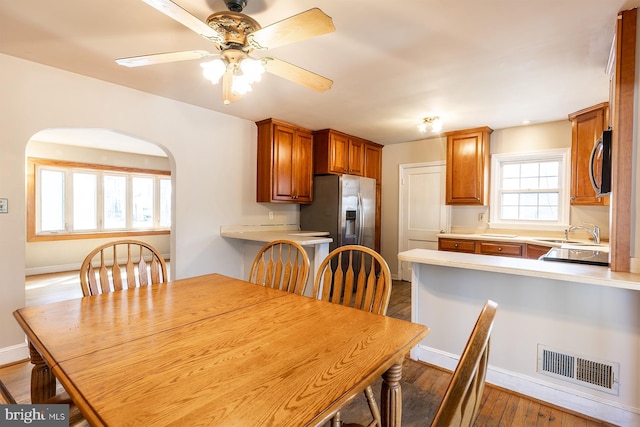 526 Baltimore Annapolis Blvd, Severna Park, MD 21146 - dining room with visible vents, baseboards, ceiling fan, wood finished floors, and arched walkways