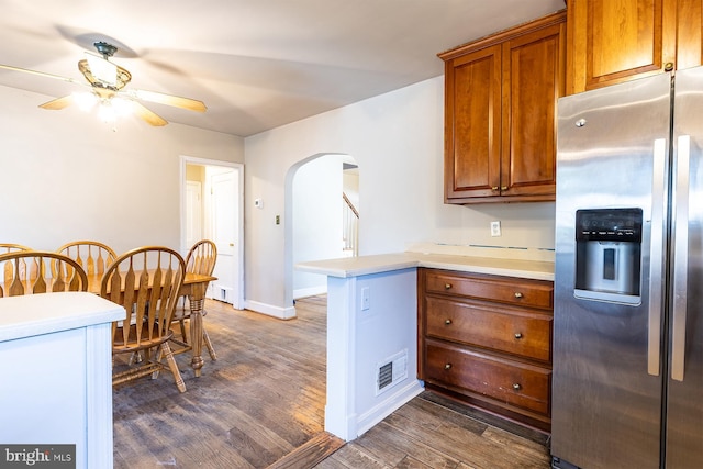 526 Baltimore Annapolis Blvd, Severna Park, MD 21146 - kitchen with a peninsula, stainless steel fridge with ice dispenser, arched walkways, dark wood-style flooring, and ceiling fan