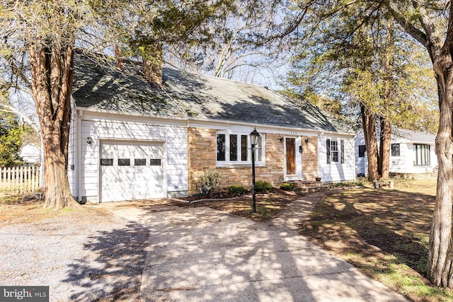 526 Baltimore Annapolis Blvd, Severna Park, MD 21146 - cape cod-style house with stone siding, fence, concrete driveway, an attached garage, and a shingled roof