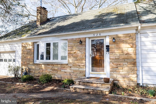 526 Baltimore Annapolis Blvd, Severna Park, MD 21146 - property entrance featuring a garage, stone siding, roof with shingles, and a chimney
