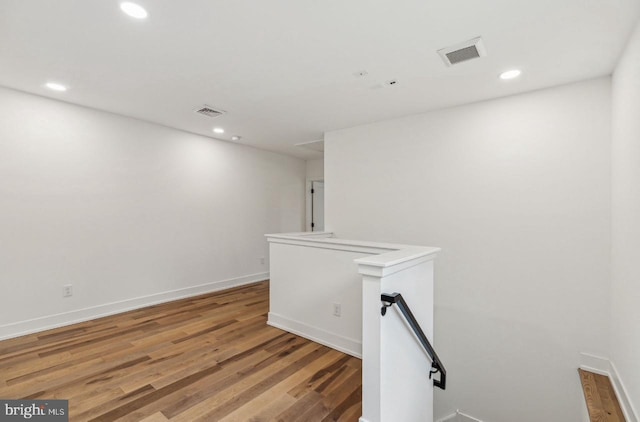 empty room featuring recessed lighting, visible vents, and light wood-type flooring