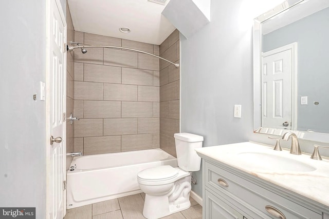 bathroom featuring vanity, toilet, visible vents, bathtub / shower combination, and baseboards