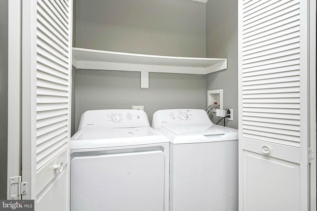 clothes washing area featuring washer and dryer and laundry area