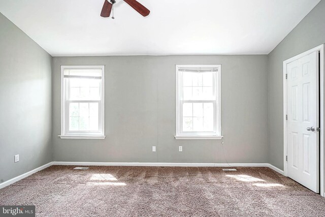 unfurnished bedroom featuring carpet, visible vents, and baseboards