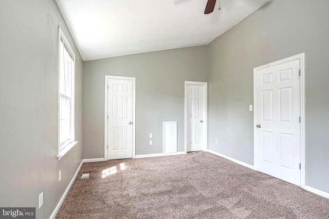 unfurnished bedroom with ceiling fan, two closets, visible vents, baseboards, and carpet floors