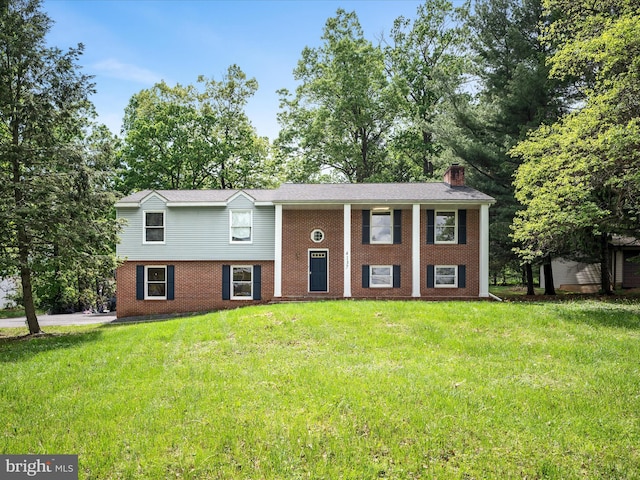 4137 Hedgesville Rd, Hedgesville, WV 25427 - raised ranch with brick siding, a chimney, and a front yard
