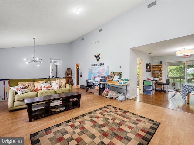 4137 Hedgesville Rd, Hedgesville, WV 25427 - living room featuring a chandelier, wood finished floors, and high vaulted ceiling