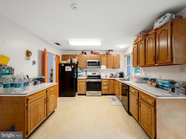4137 Hedgesville Rd, Hedgesville, WV 25427 - kitchen featuring black appliances, light floors, light countertops, and a sink
