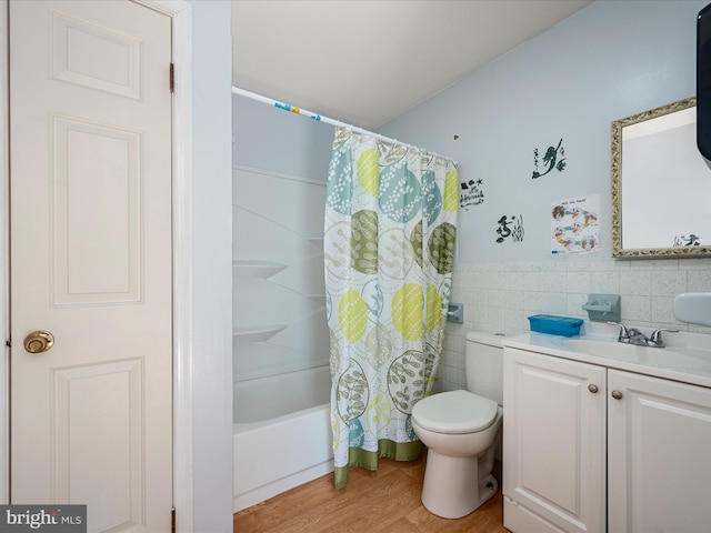4137 Hedgesville Rd, Hedgesville, WV 25427 - full bathroom with tile walls, toilet, wood finished floors, vanity, and a wainscoted wall