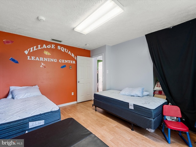 4137 Hedgesville Rd, Hedgesville, WV 25427 - bedroom featuring a textured ceiling and wood finished floors