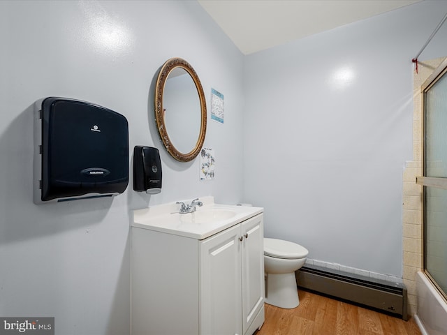 4137 Hedgesville Rd, Hedgesville, WV 25427 - full bathroom featuring a baseboard heating unit, wood finished floors, vanity, toilet, and shower / bath combination with glass door