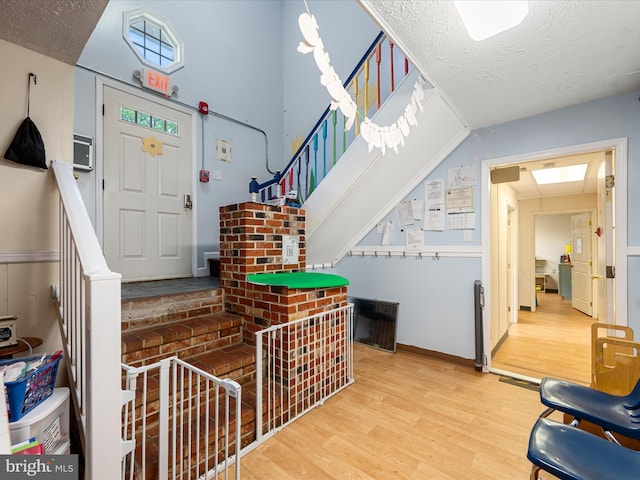 4137 Hedgesville Rd, Hedgesville, WV 25427 - foyer entrance with wood finished floors, a textured ceiling, and stairs