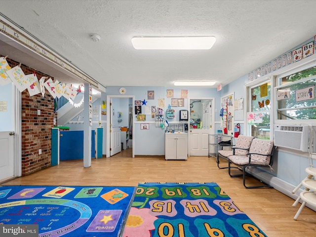 4137 Hedgesville Rd, Hedgesville, WV 25427 - playroom featuring wood finished floors, a textured ceiling, and cooling unit