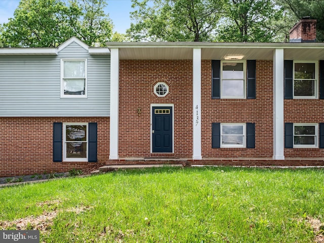 4137 Hedgesville Rd, Hedgesville, WV 25427 - view of front of home featuring brick siding, a front lawn, and a chimney