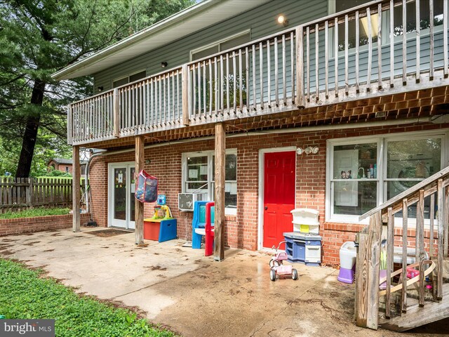 4137 Hedgesville Rd, Hedgesville, WV 25427 - back of house featuring a balcony, brick siding, a patio, and fence