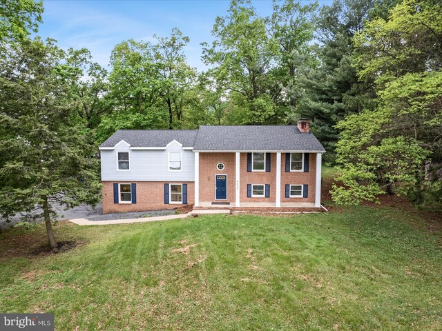 4137 Hedgesville Rd, Hedgesville, WV 25427 - bi-level home with brick siding, a front lawn, and a chimney