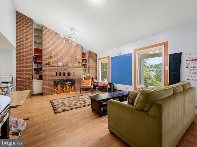 4137 Hedgesville Rd, Hedgesville, WV 25427 - living room featuring plenty of natural light, wood finished floors, a brick fireplace, high vaulted ceiling, and a chandelier